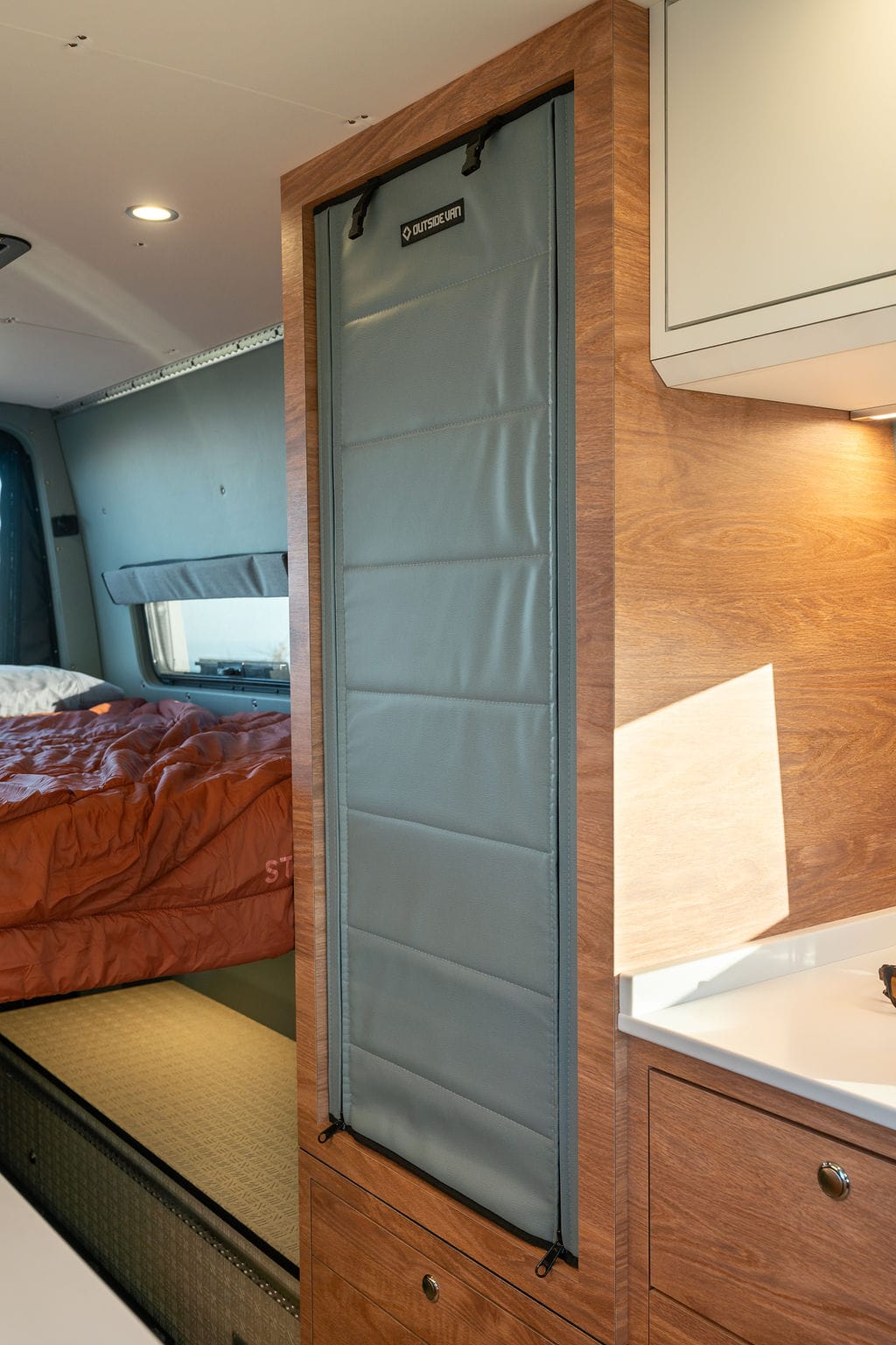 Closet in a 170" sprinter van conversion built by Outside Van