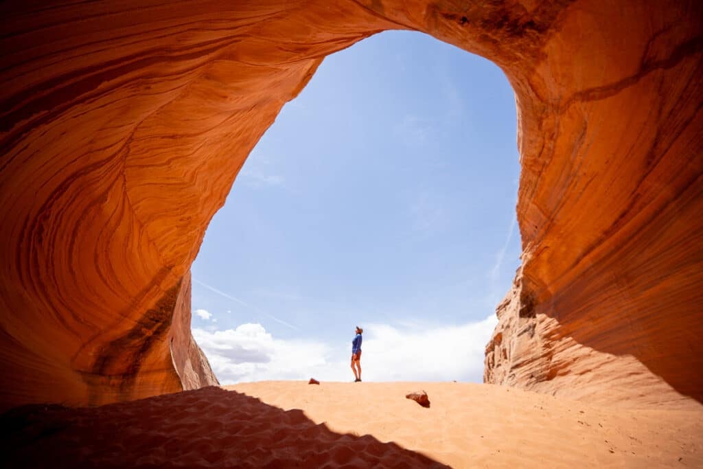 woman standing in a cave in Page Arizona
