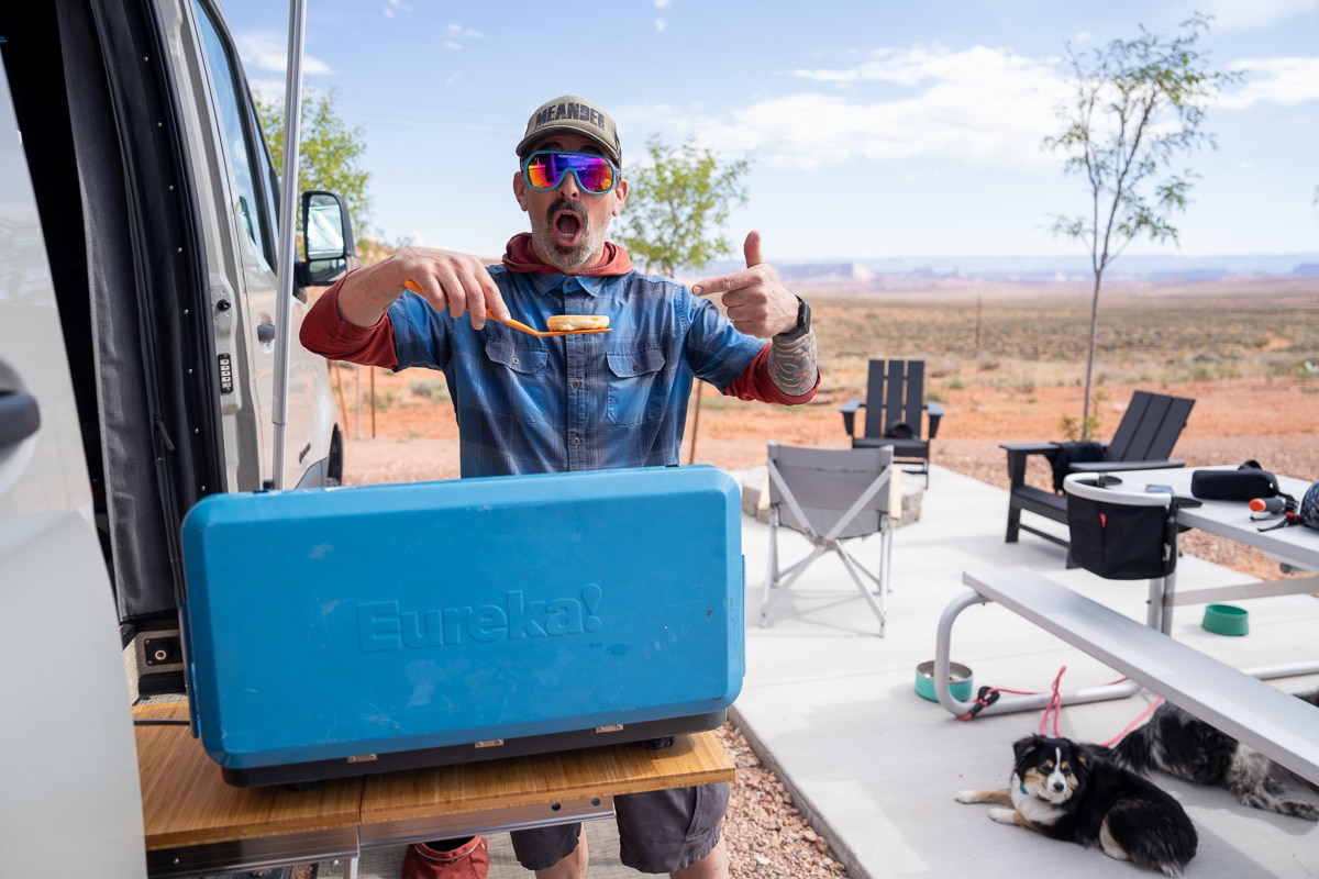 Man making pancakes on a camp stove at a campsite at Roam Horseshoe Bend RV Resort