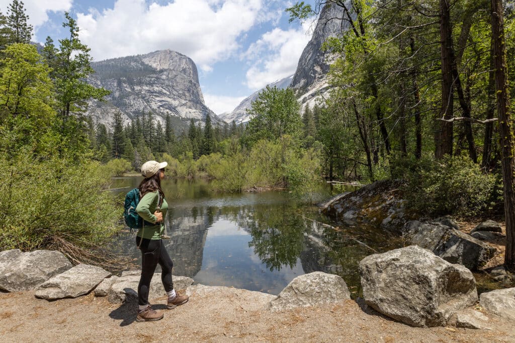 Woman standing at the edge of Mirror Lake in Yosemite