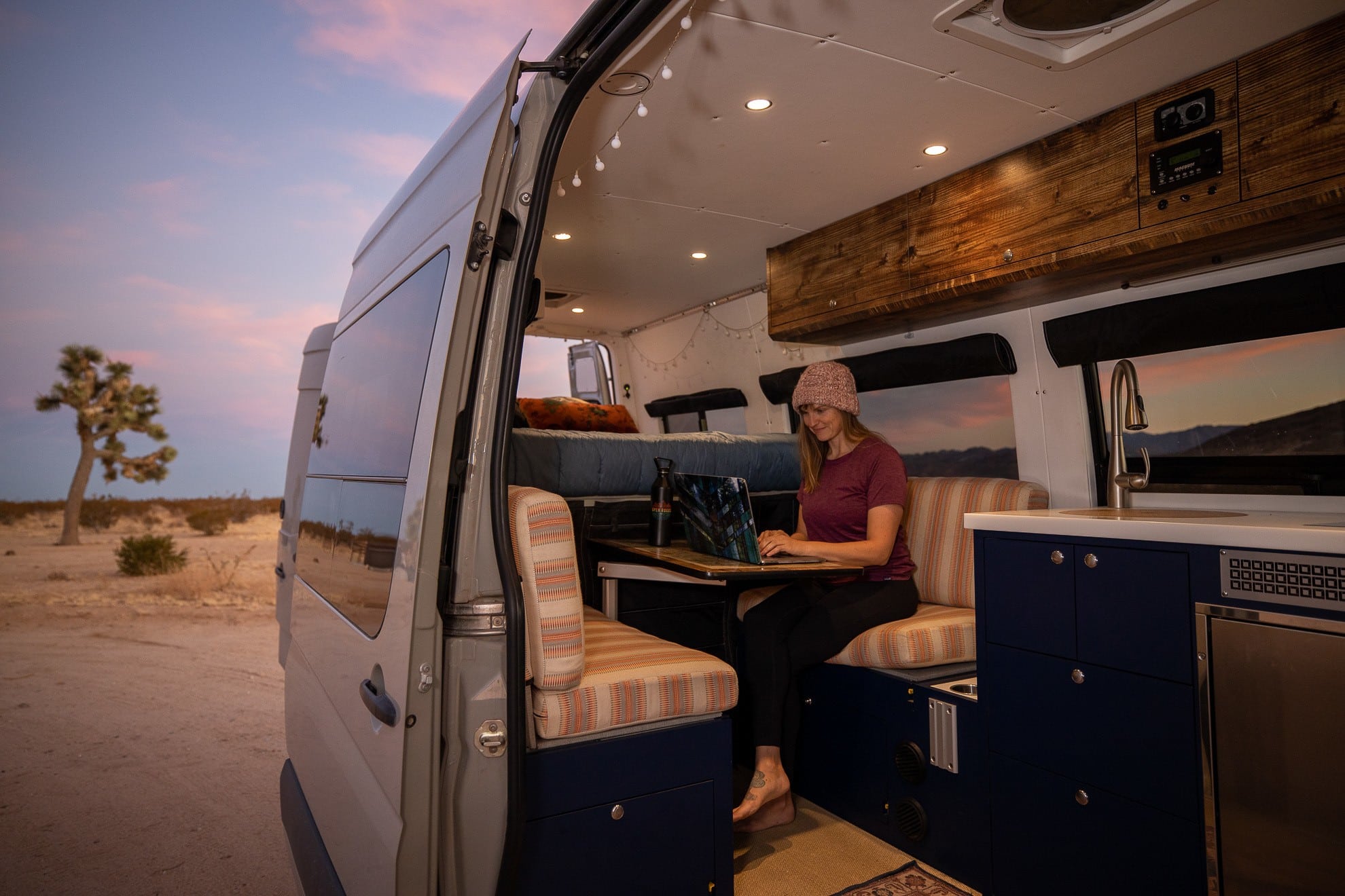 Bearfoot Theory founder Kristen Bor working in her Sprinter Van outside of Joshua Tree