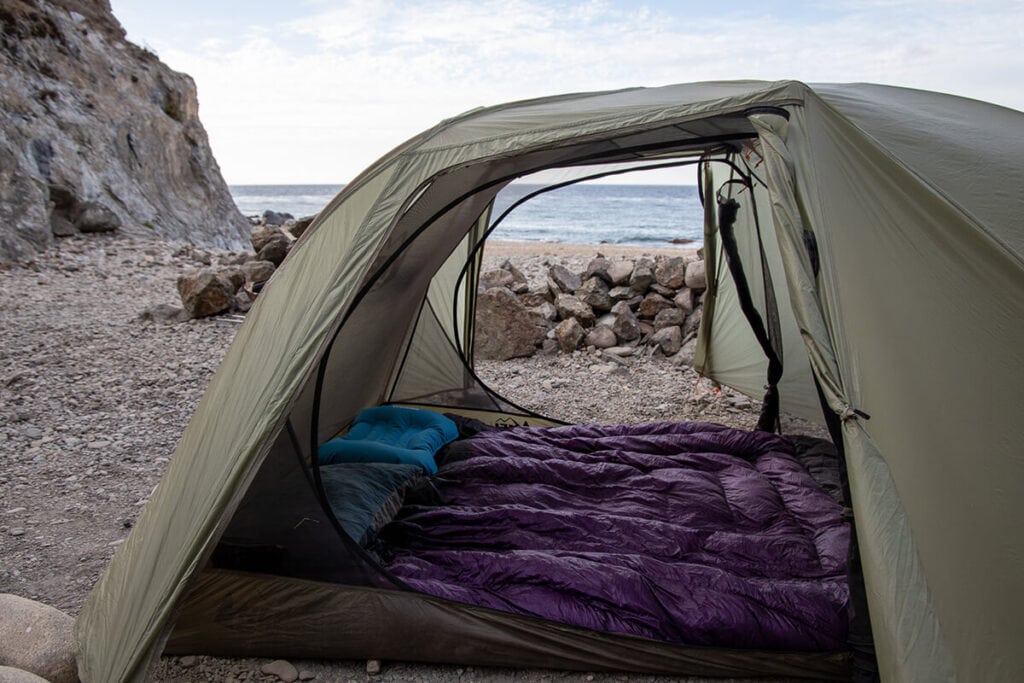 Looking through the side of a green backpacking tent to the other side