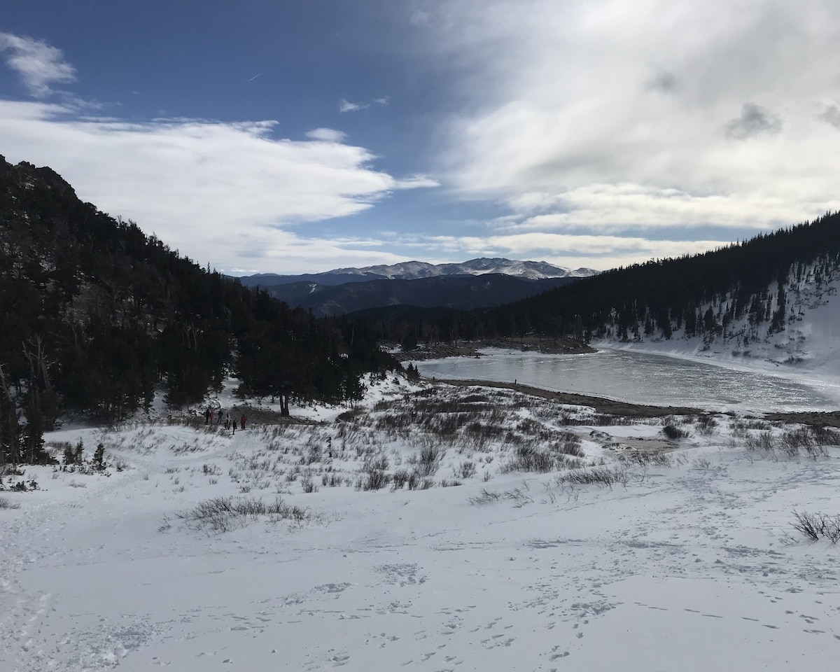 View of the Rocky Mountains from the side of Saint Mary's Glacier in Colorado with snow on the ground