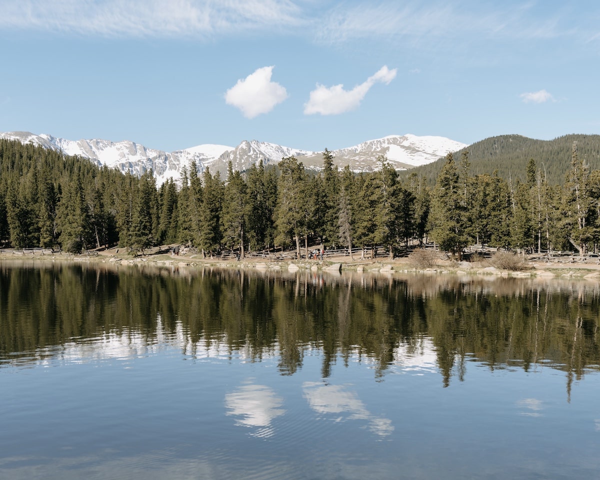 Reflection of mountain and trees in the blue water of Echo Lake in Colorado
