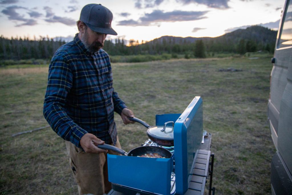 Man cooking on a cap stove
