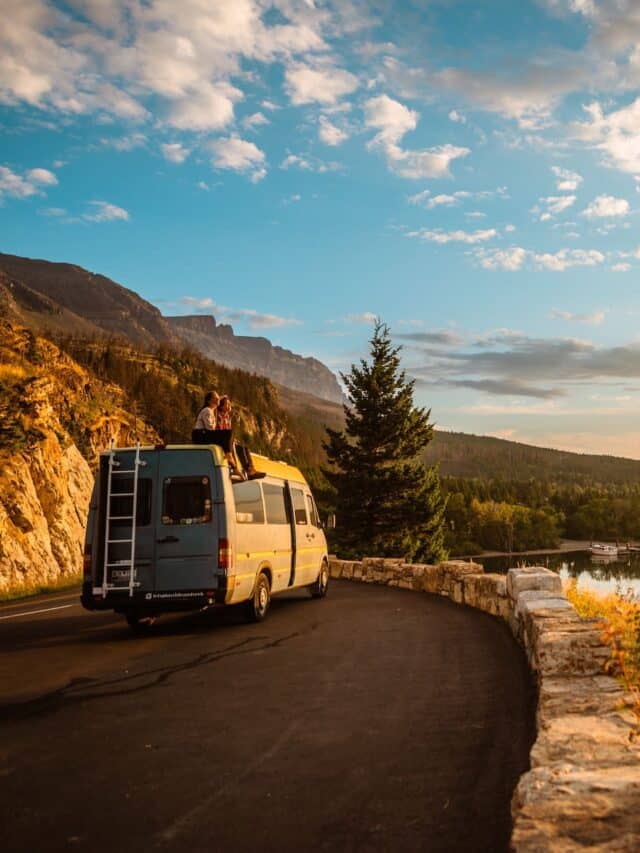 Campervan parked on the side of the road in a scenic coastal area at sunset