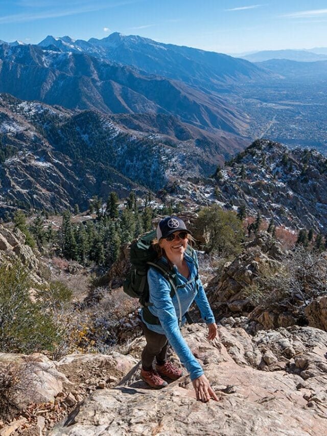 Women standing on rocky section of the Mount Olympus Trail overlooking Salt Lake City Utah