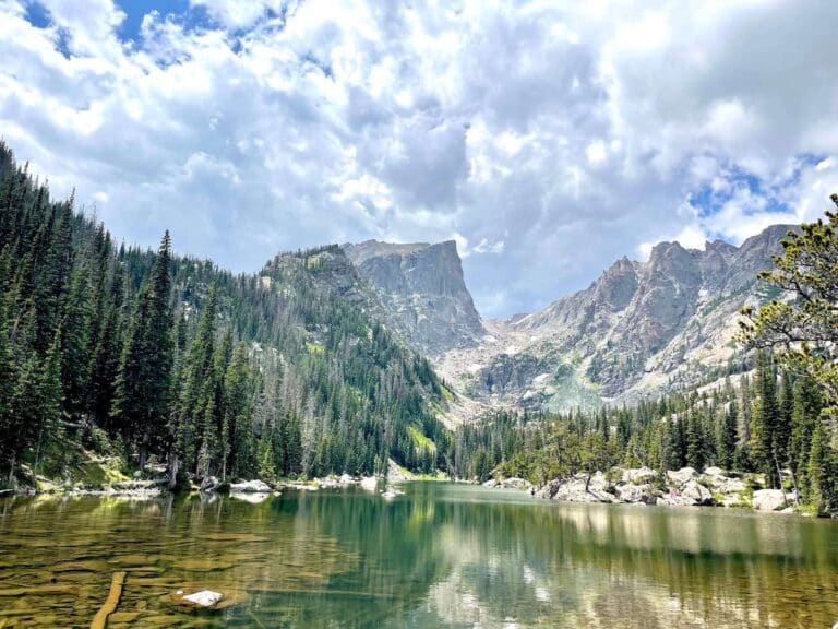 Photo out over Emerald Lake in Rocky Mountain National Park with tall, rocky mountains as a backdrop