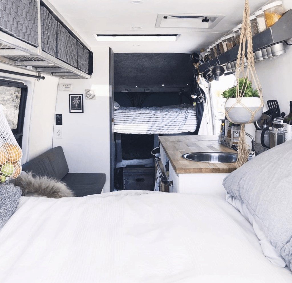 The interior of a family campervan with two beds