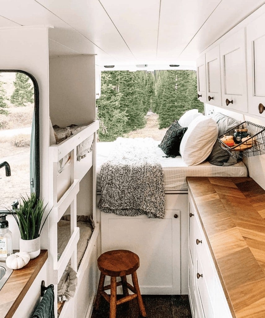 Two kids bunk beds built into the wall of a family camper van 