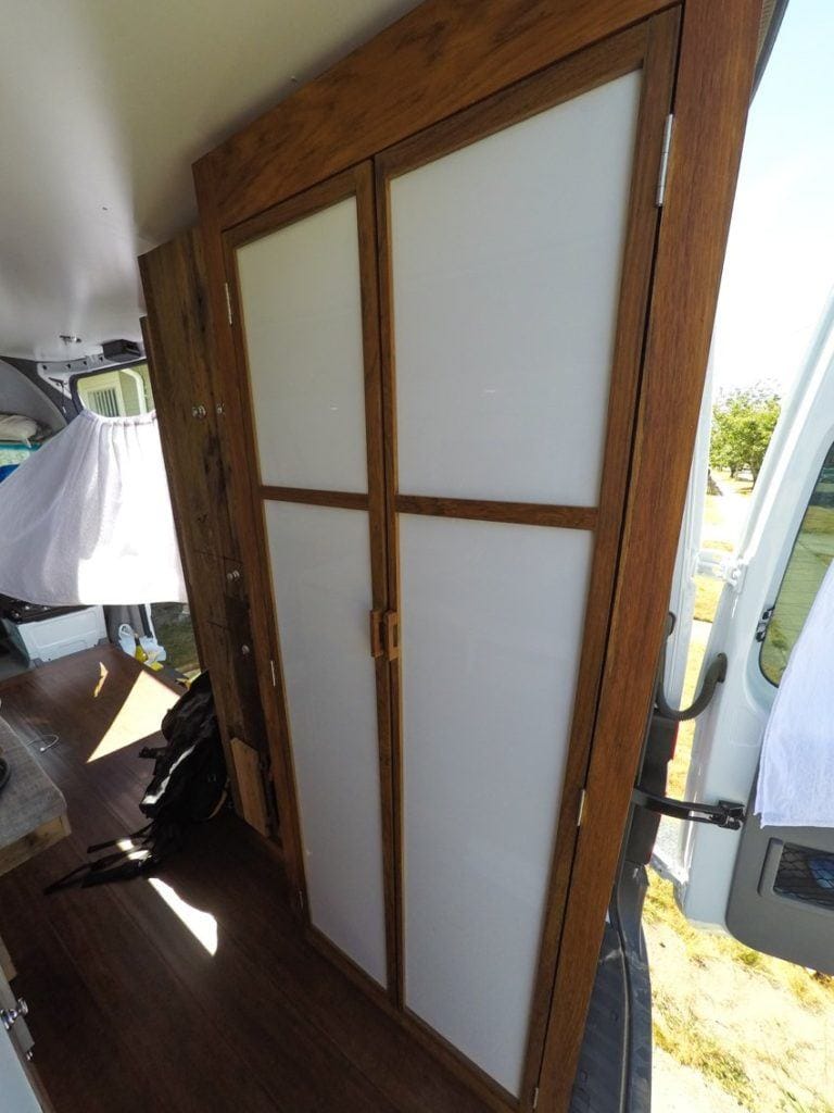 Enclosed bathroom in rear of converted sprinter van