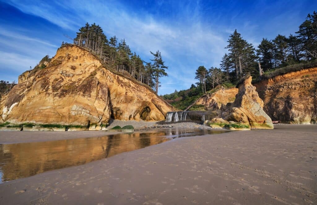 Waterfall at sandy beach at Hug Point in Oregon