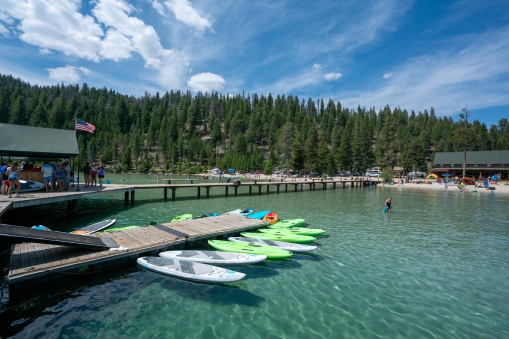 Paddleboards floating next to the dock at redfish lake in stanely idaho