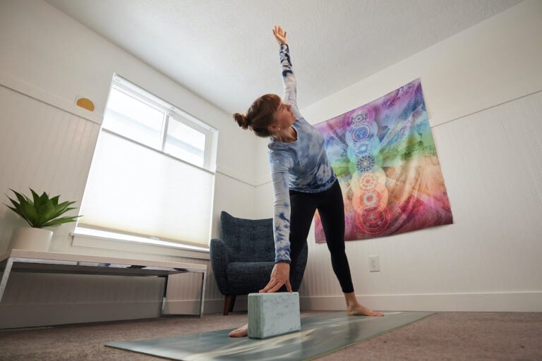 Woman doing yoga at home modeling top lululemon must-haves for working out