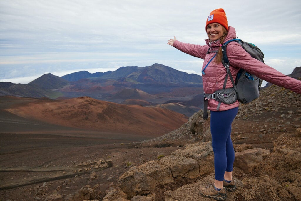 Woman posing for photo at the summit of Haleakala on Maui wearing Patagonia nano puff jacket