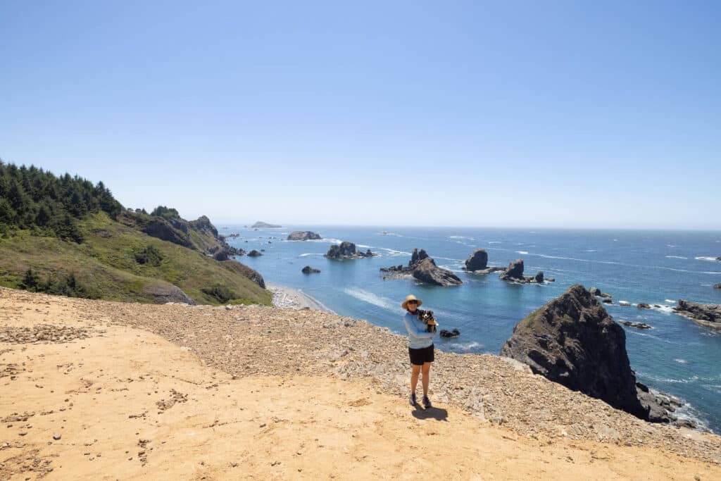 Woman holding dog at Oregon Coast lookout on Lone Rock Beach