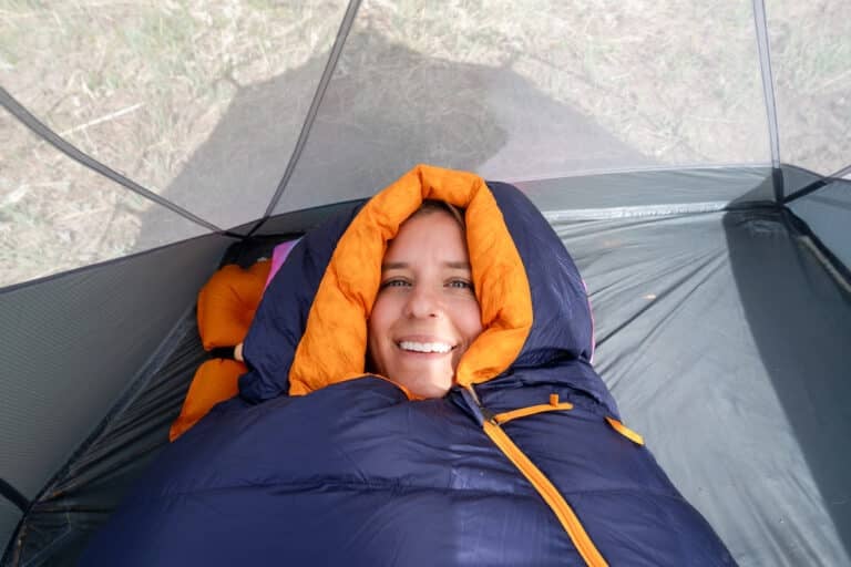 Close up of a woman's head inside of the hood of the REI Magma sleeping bag