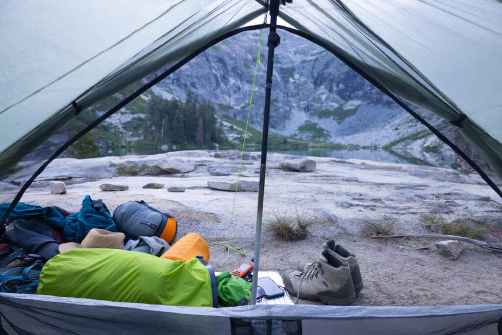 Tent pitched at Hamilton Lake in Sequoia with gear, including sleeping bag, hat, Garmin, and clothes