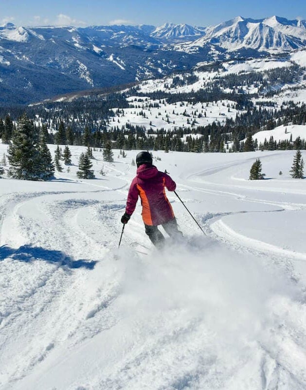 Woman skiing down mountain in Colorado
