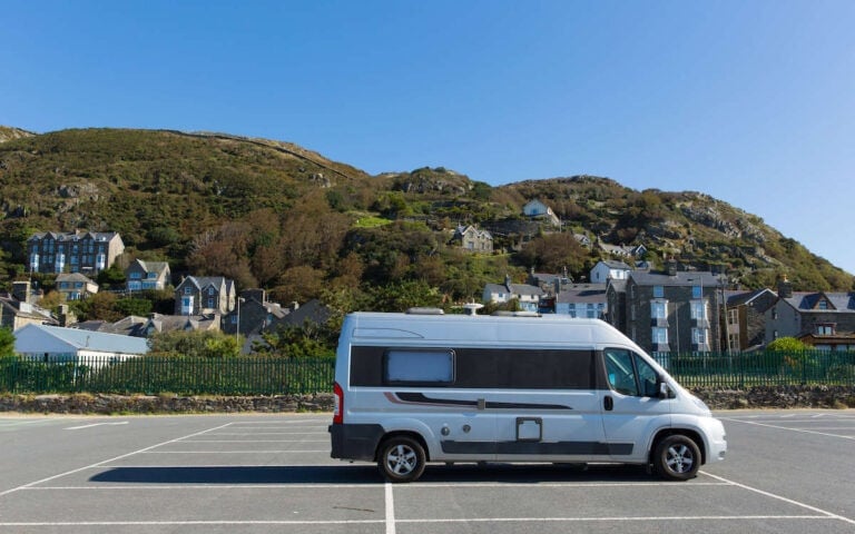 Campervan parked in parking lot with no other cars