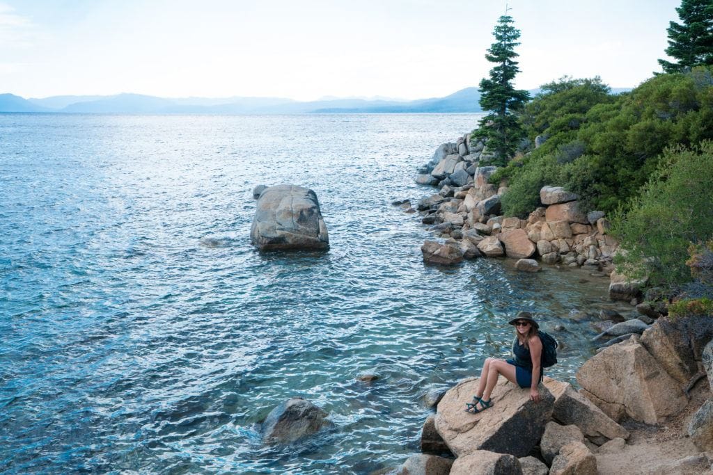 Kristen Bor sitting on the beach of lake Tahoe
