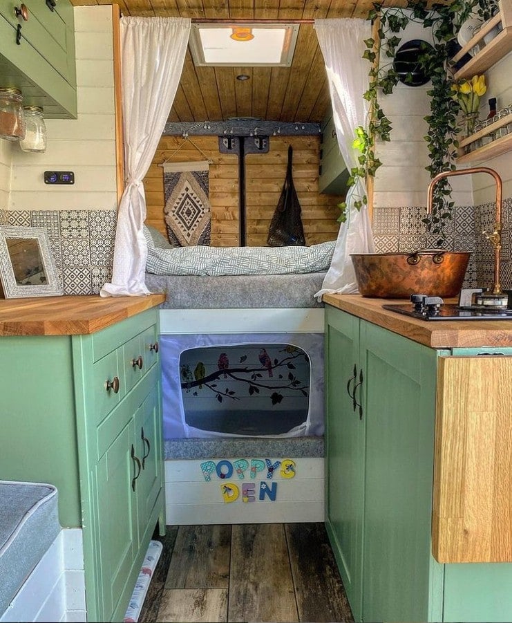 A camper van family layout with a small den underneath a full size bed for a child