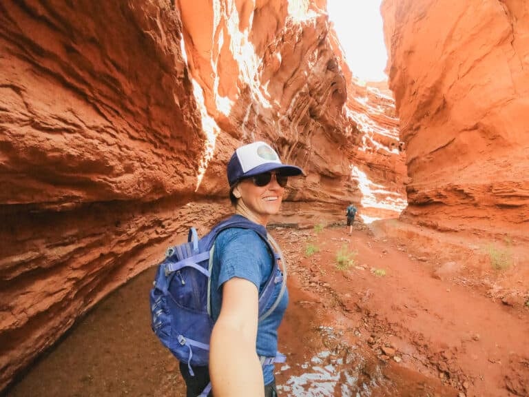 Woman hiking in canyon to Mary Jane Falls in Moab Utah