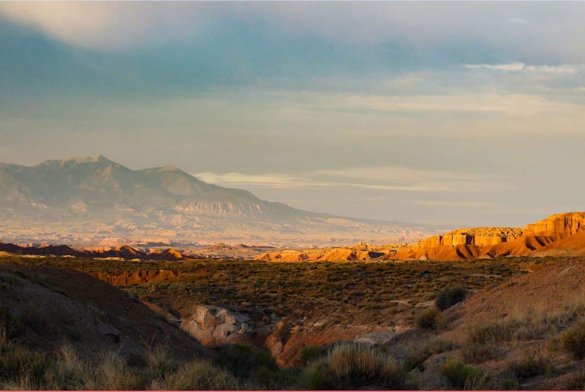 A view of the mountains along Curtis Bench trail at golden hour in Goblin Valley State Park in Utah