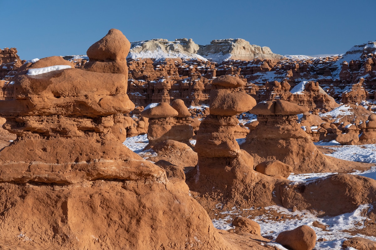 The goblins with snow on them during winter in Goblin Valley State Park in Utah