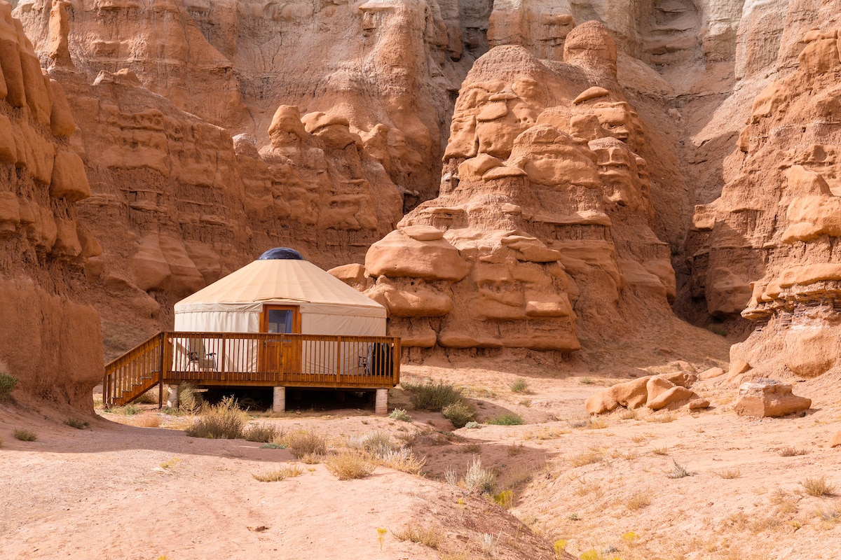 A yurt in Goblin Valley State Park in Utah surrounded by orange rock formations
