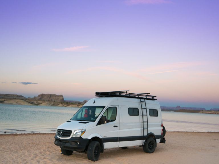 Sprinter van parked in front of lake in Arizona at sunset