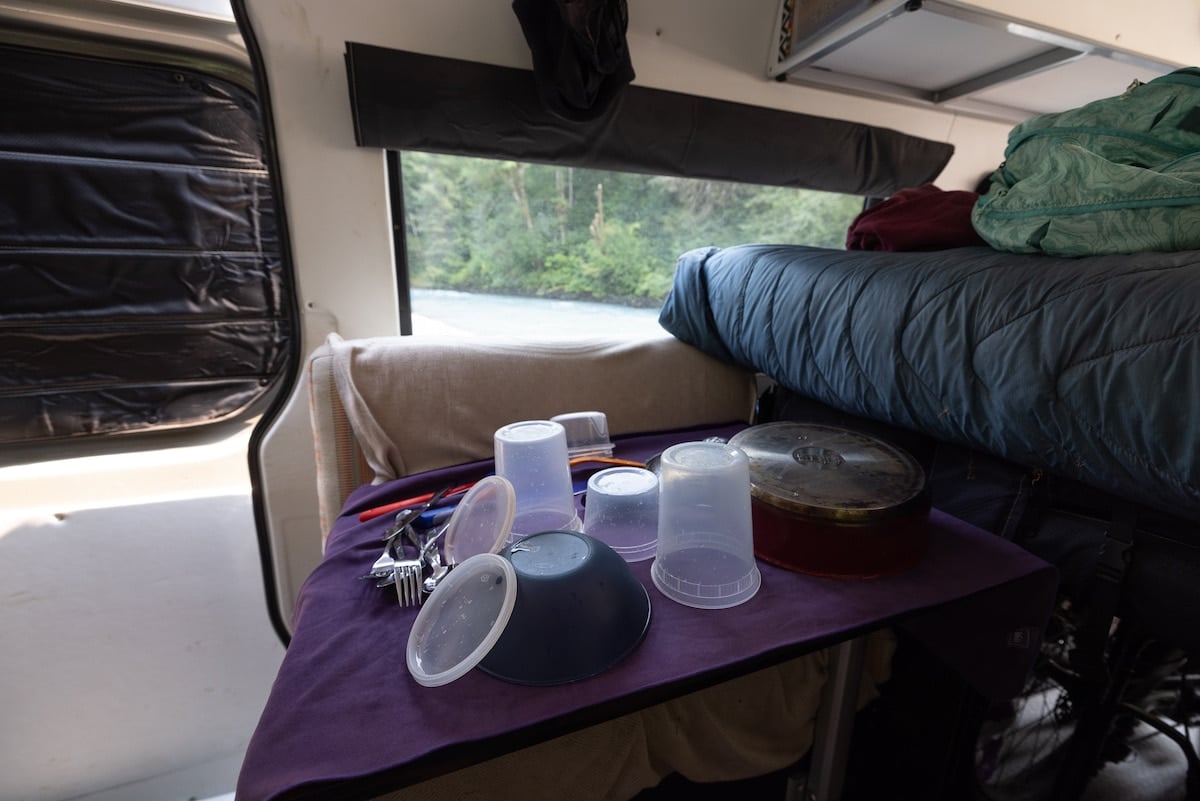 Clean dishes sitting on a towel to dry in a camper van