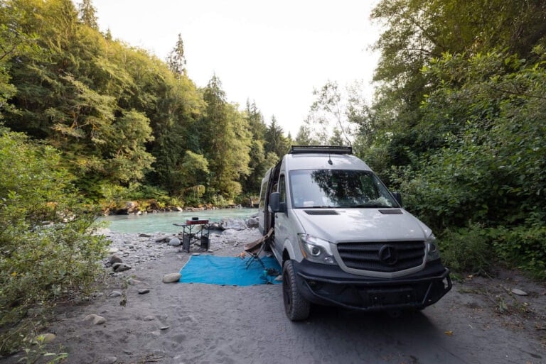 Van parked in dispersed campsite next to river on the Olympic Peninsula in Washington